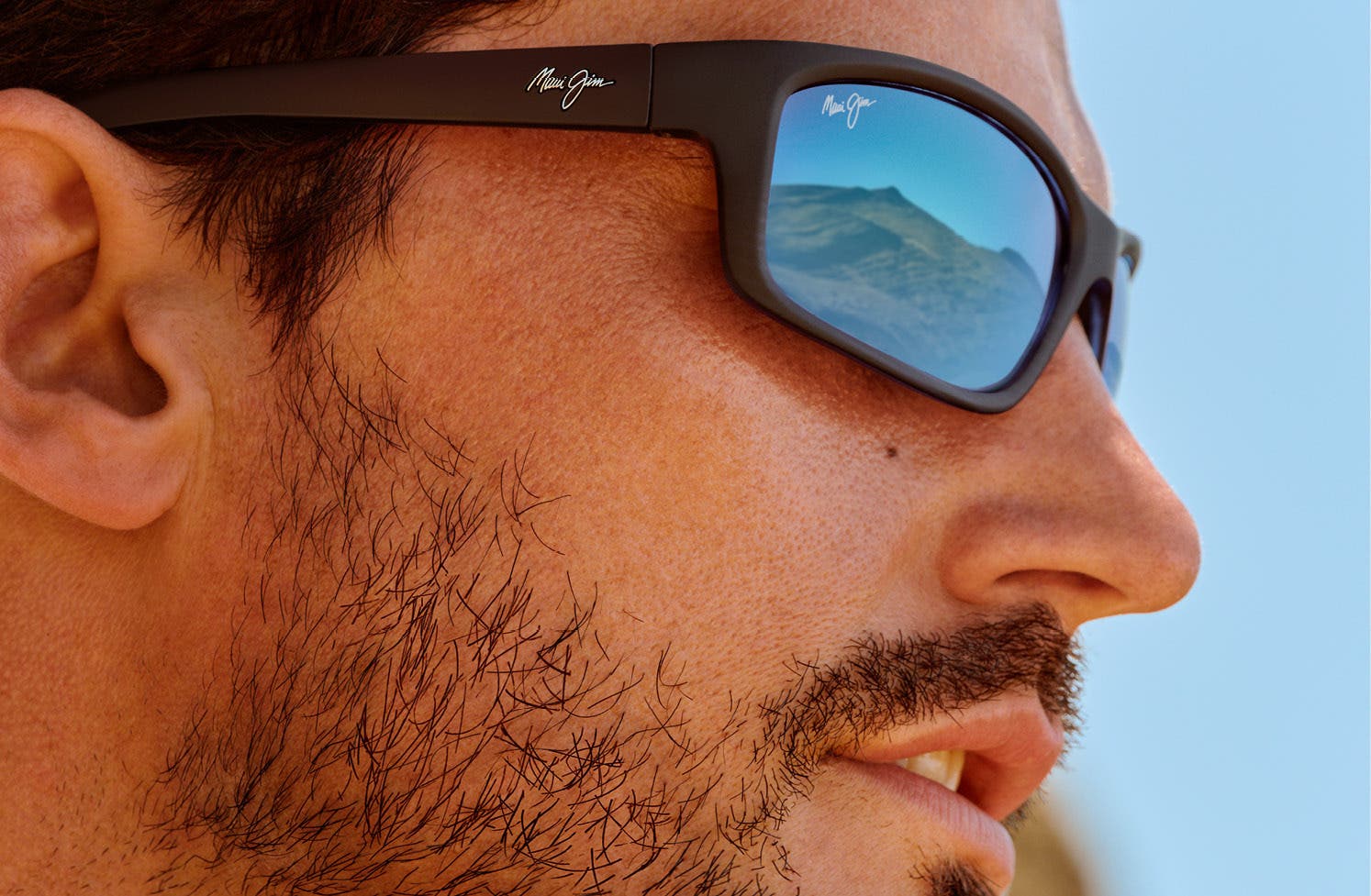 Man wearing Maui Jim Kanaio Coast sunglasses on face